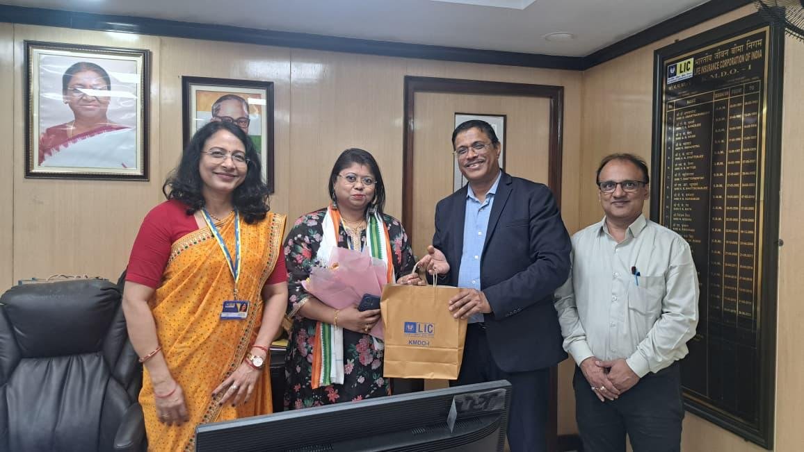 Rina Mukherjee with colleagues at an office